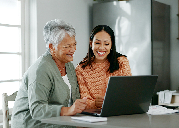 Senior woman and daughter in kitchen with laptop (2) 1